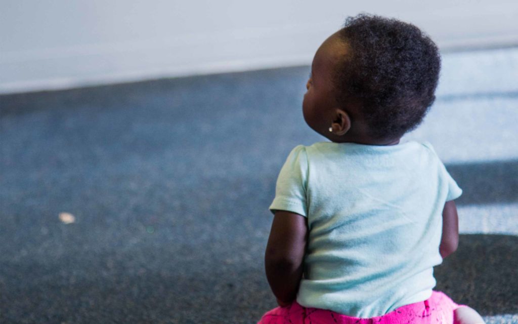 Child with her back turned to the camera